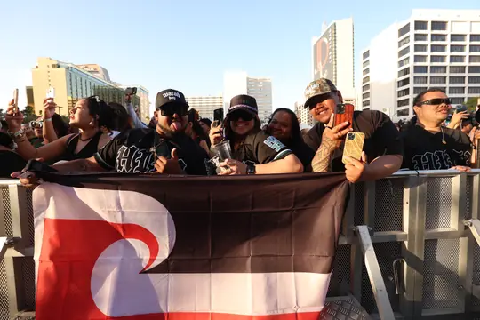 Fans holding a Tino Rangatiratanga flag in the stands