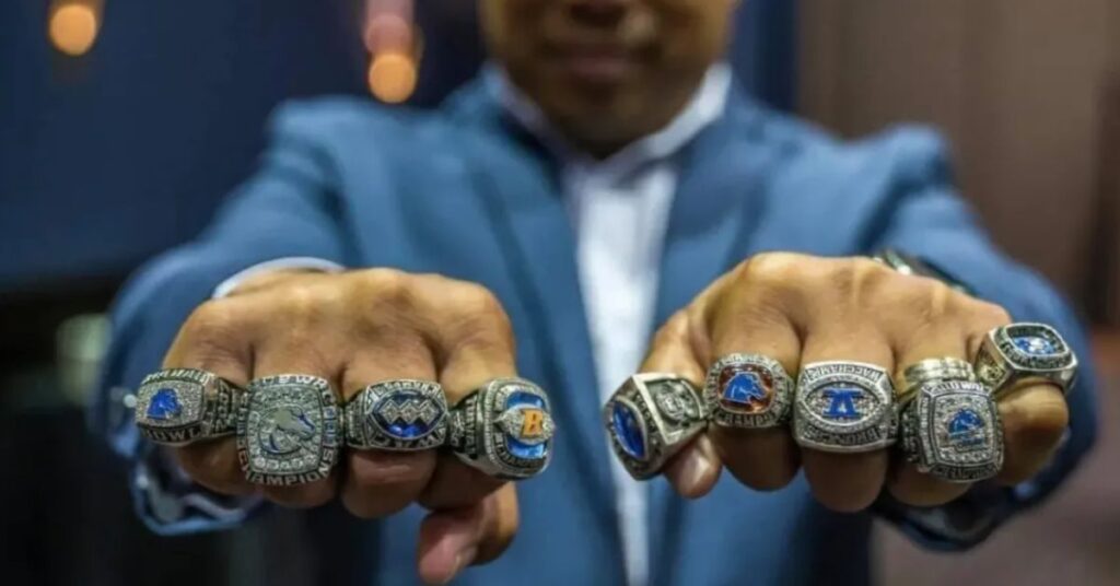 Coach V holding his championship rings as a symbol of leadership, success, and excellence in coaching